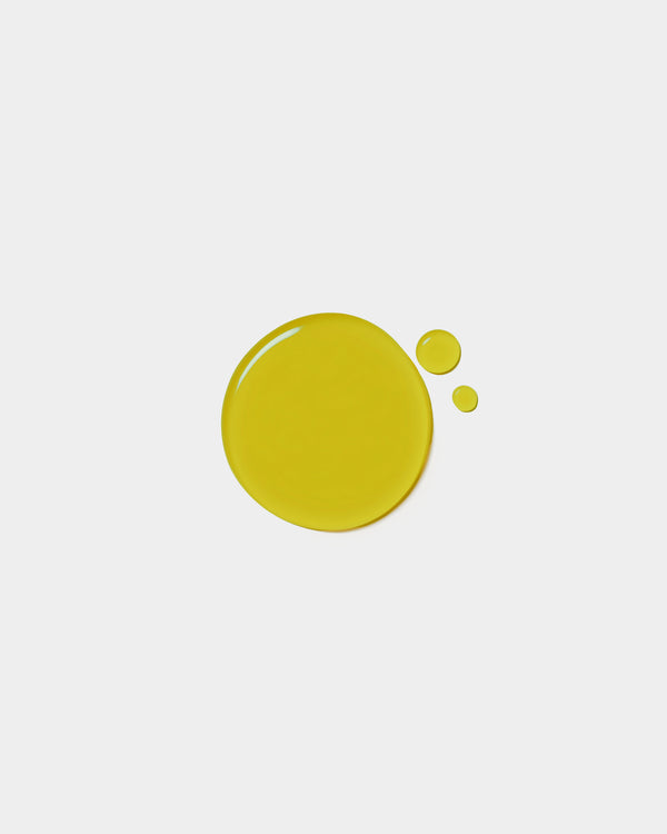 Nourishing Face Oil formula swatch — vivid olive green botanical oil drop on white surface